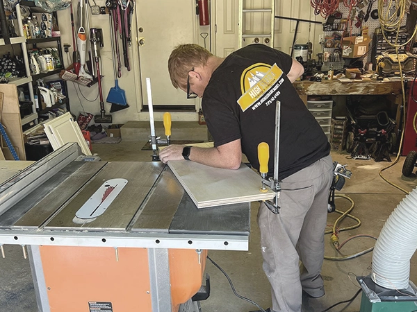 a contractor from High Sierra building a cabinet with plywood