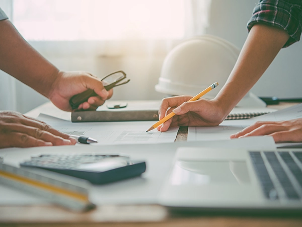 A man and a woman drawing plans for a remodel