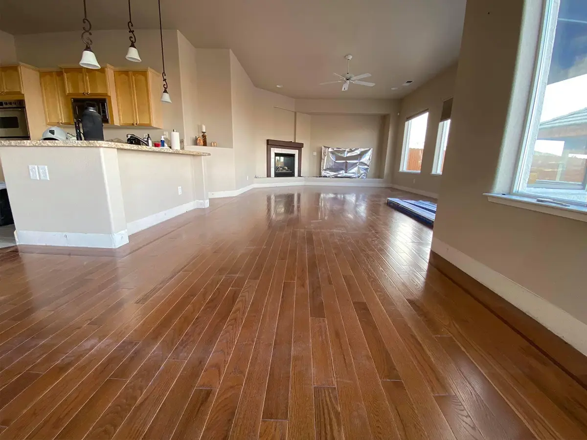 A large open space kitchen with wood flooring and a fireplace