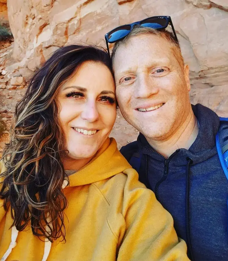 A man and a woman in a yellow hoodie