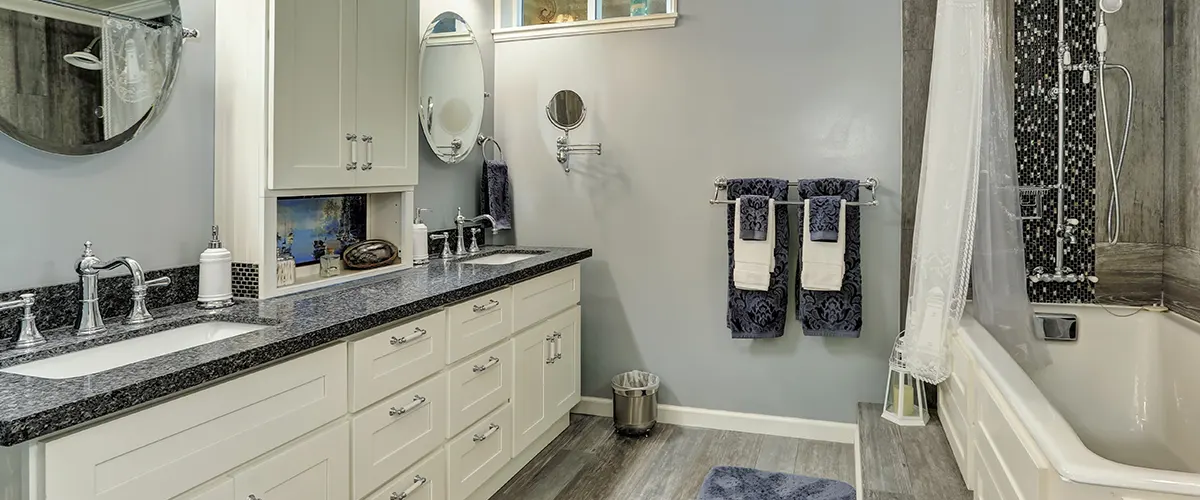 bathroom with black marble countertops