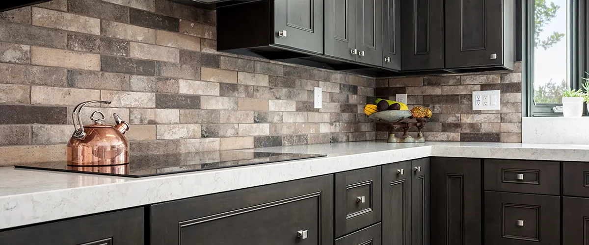 kitchen with black cabinets and marble countertops