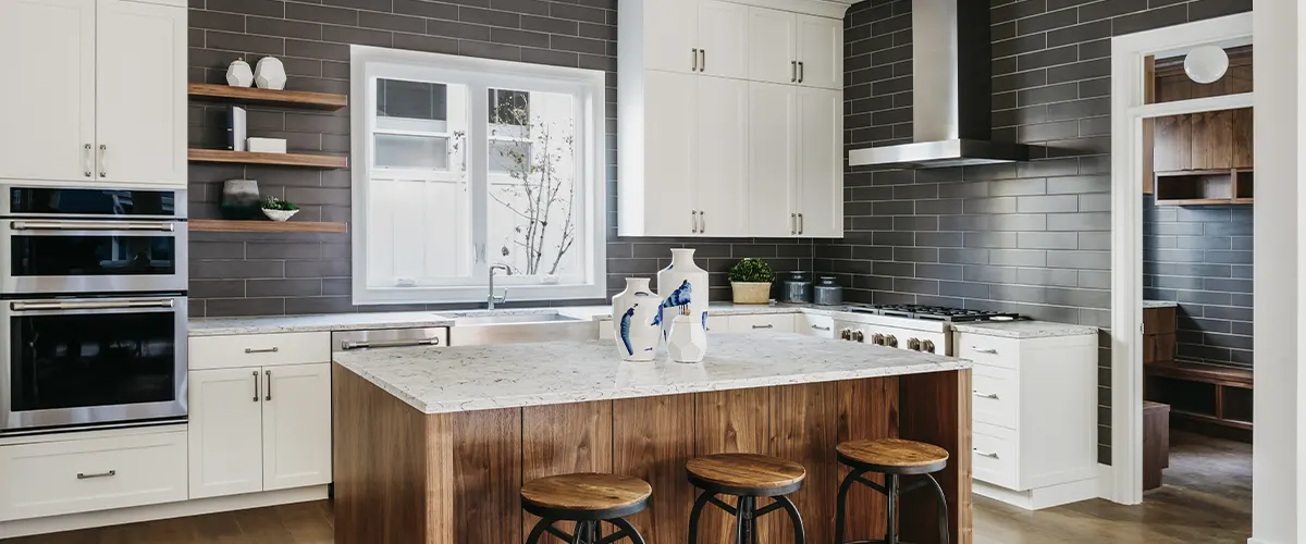 kitchen with black wall tile and white cabinets