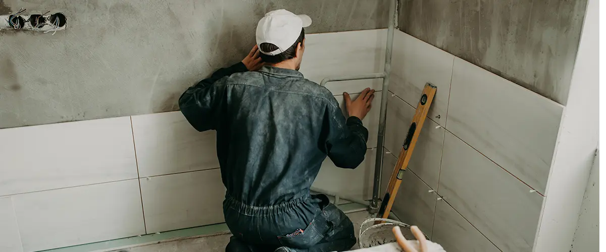 A bathroom contractor installing tile walls