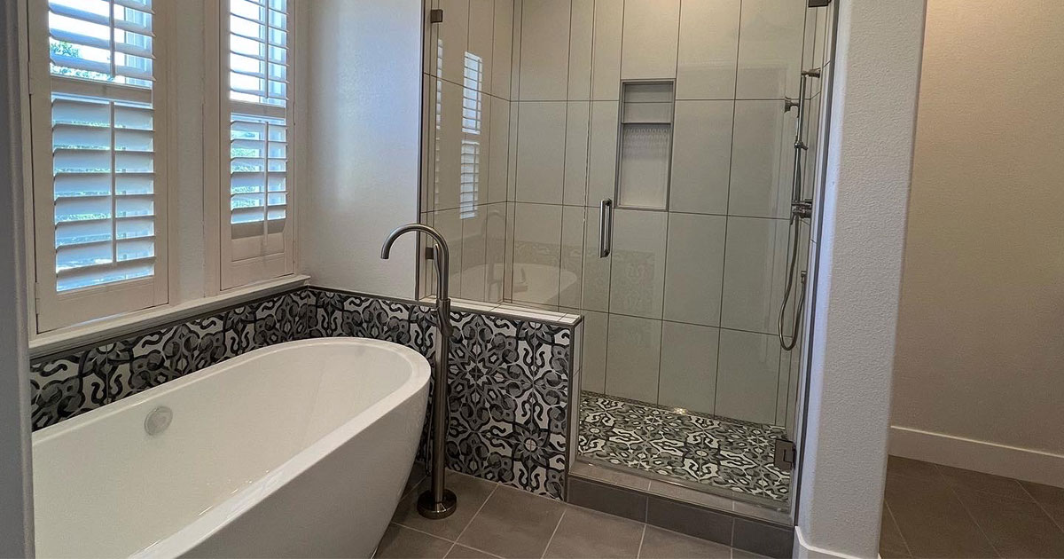 Freestanding tub and walk-in shower with glass door in bathroom remodeling in Montreaux