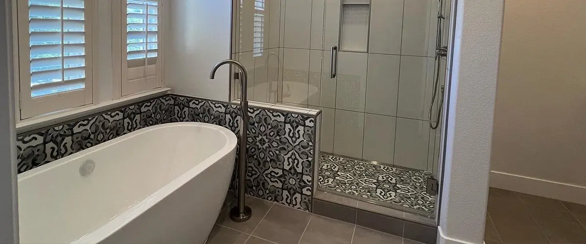 Freestanding tub and walk-in shower with glass door in bathroom remodeling in Montreaux
