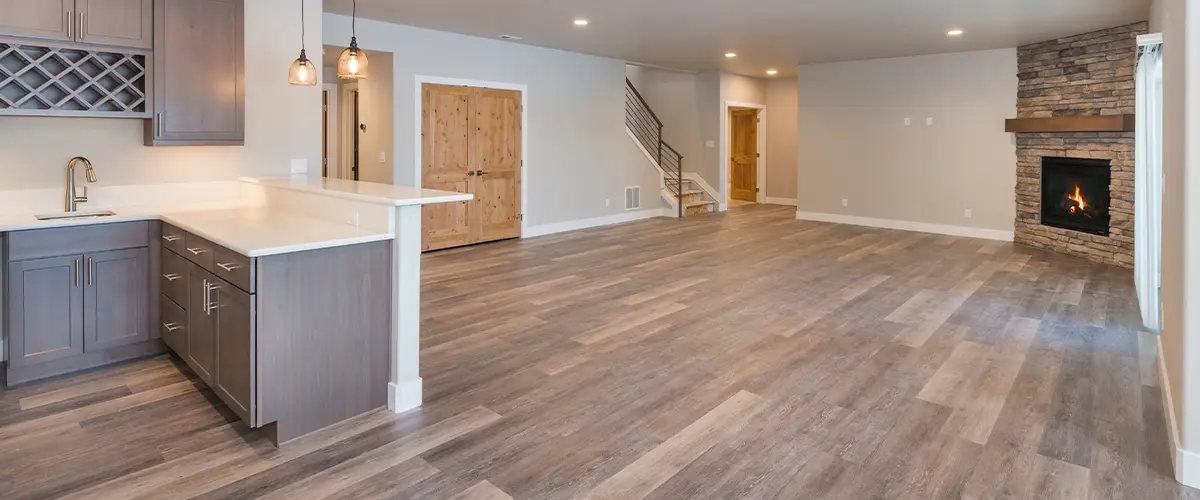 LVP flooring in a basement with a kitchenette