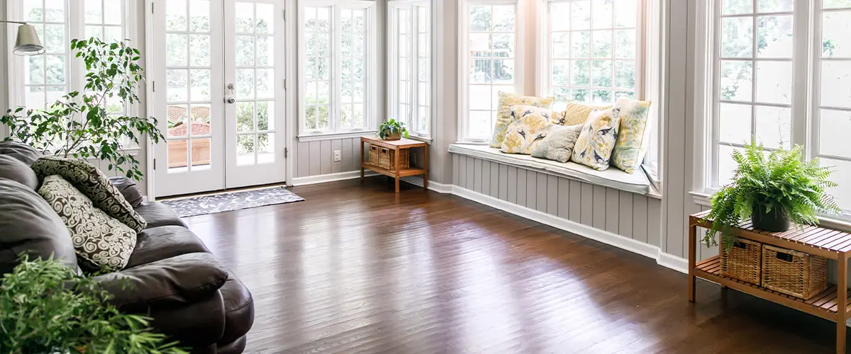 Sunroom with wood flooring and plants