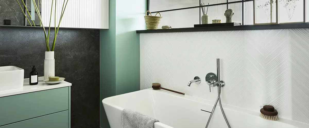 Stylish and creative minimalistic small bathroom interior design with marble walls with green panels, plants and beautiful bathroom accessories. Minimalistic home concept