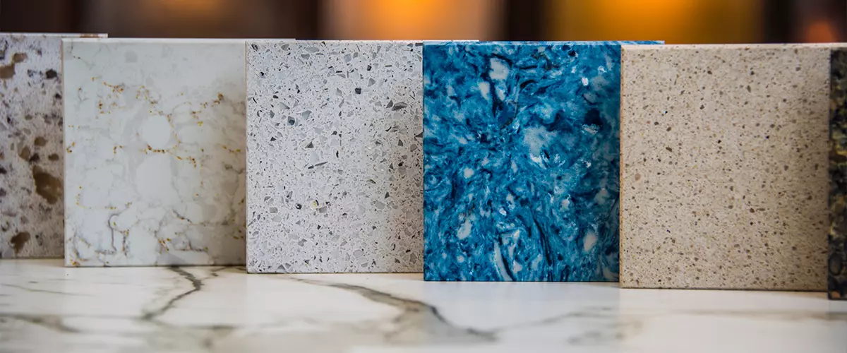 five square samples of kitchen countertops white brown, blue, white gray, withe with grans on kitchen countertops surface of marble stone.