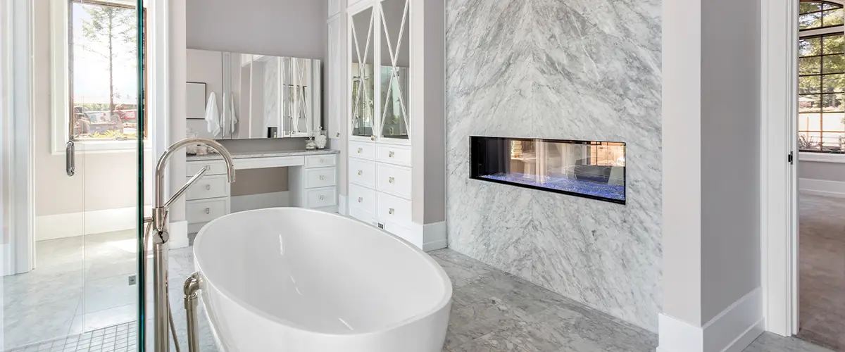 Luxurious Master Bathroom in New Home with Fireplace and Large Bathtub