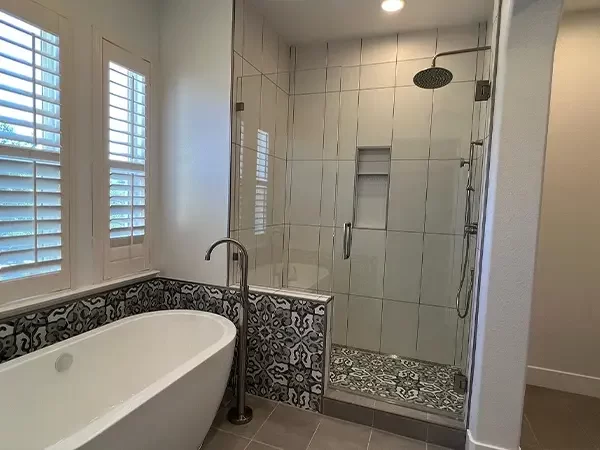 High Sierra bathroom remodeling project featuring Modern bathroom with freestanding tub, glass shower, and patterned tiles